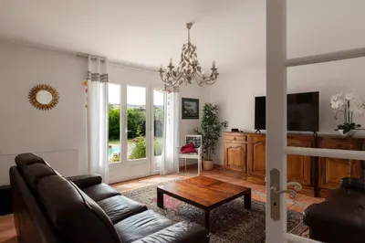 a living room with a couch and a table at Villa La Cavayere swimming pool air conditioning in Carcassonne