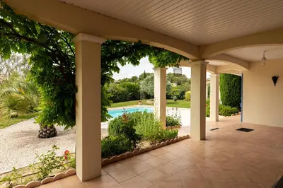 an external view of a house with a patio with a pool at Villa La Cavayere swimming pool air conditioning in Carcassonne