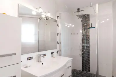 a white bathroom with a sink and a shower at Villa La Cavayere swimming pool air conditioning in Carcassonne