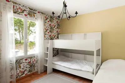 a bedroom with a white bunk bed and a window at Villa La Cavayere swimming pool air conditioning in Carcassonne