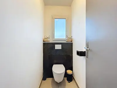 a bathroom with a toilet and a window at Villa Grivia - Maison avec grand jardin - Piscine - Pétanque - Ping Pong in Saint-André-de-Roquelongue