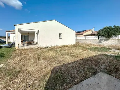 a white house on top of a field of grass at Villa Grivia - Maison avec grand jardin - Piscine - Pétanque - Ping Pong in Saint-André-de-Roquelongue