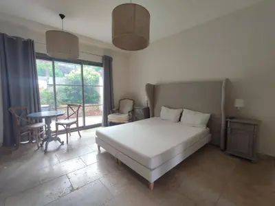 a bedroom with a white bed and a table and chairs at La Redorte 14 in La Redorte