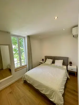 a bedroom with a bed and a large window at T3 Lumineux & Cosy avec Balcon Escapade by DarBonne in Narbonne