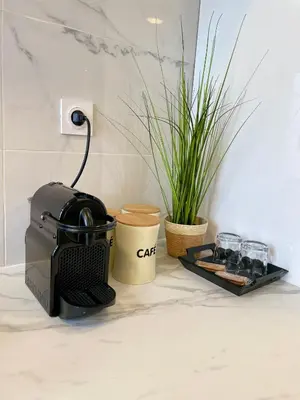 a coffee maker on a counter next to a plant at T3 Lumineux & Cosy avec Balcon Escapade by DarBonne in Narbonne