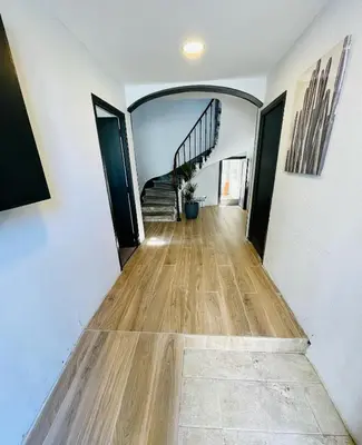 a hallway with a staircase in a house at T3 Lumineux & Cosy avec Balcon Escapade by DarBonne in Narbonne
