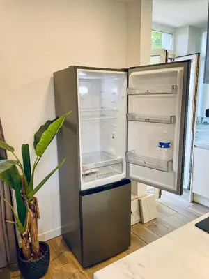 an empty refrigerator in a kitchen with a plant at T3 Lumineux & Cosy avec Balcon Escapade by DarBonne in Narbonne