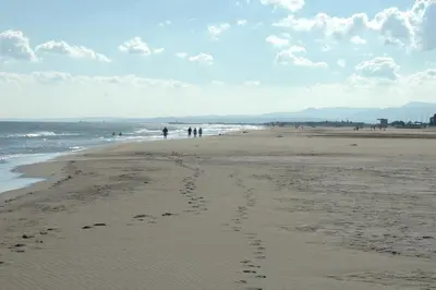 a group of people walking on the beach at B&B Domaine Méditerranée in Paraza