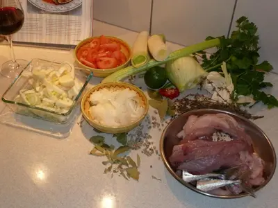 a table topped with a bowl of meat and vegetables at B&B Domaine Méditerranée in Paraza