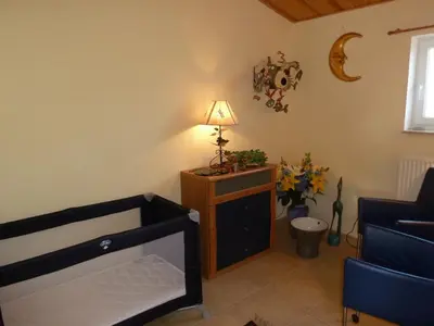 a living room with a bed and a lamp on a table at B&B Domaine Méditerranée in Paraza