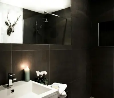 a bathroom with a white sink and a mirror at Charming Riverside House In Medieval Village in Villeneuve-Minervois