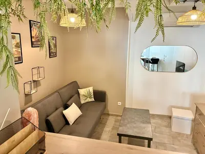 a living room with a couch and a table at Gîte Molière in Sallèles-dʼAude