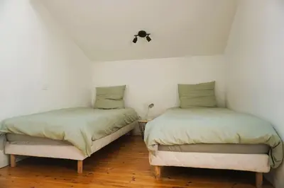 two beds sitting next to each other in a room at La Maison du Saunier entre mer et garrigue in Lapalme