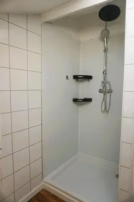 a shower with a glass door in a bathroom at La Maison du Saunier entre mer et garrigue in Lapalme