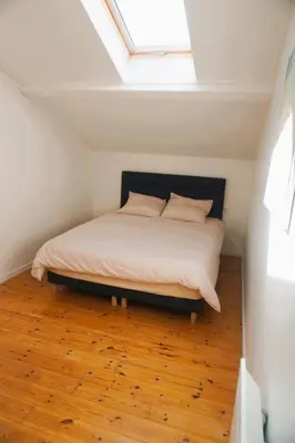 a bedroom with a bed with a skylight at La Maison du Saunier entre mer et garrigue in Lapalme