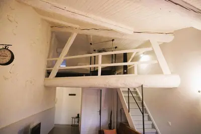 a loft bed in a room with a staircase at Le Mirador St Just 3 people City in Narbonne