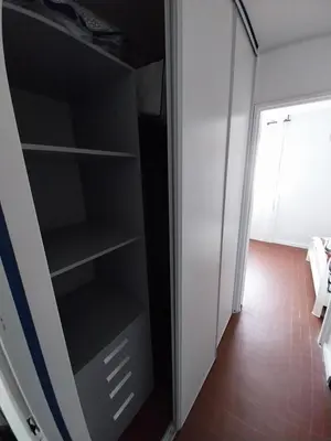 a closet with black shelves in a room at Appartement T2 lumineux à 200m de la plage, tout équipé in Port-la-Nouvelle
