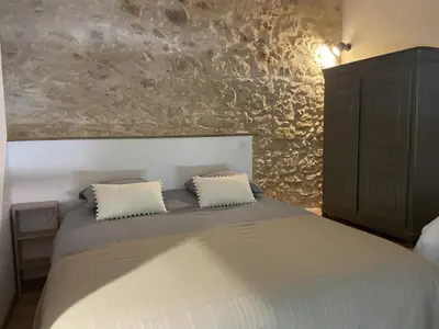 a bedroom with a bed with two pillows on it at Le Mas de l'eau - Piscine Privative in Quarante