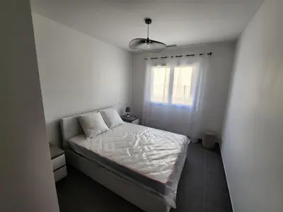a small bedroom with a bed and a window at La Villa les Terrasses du Canal in Capestang