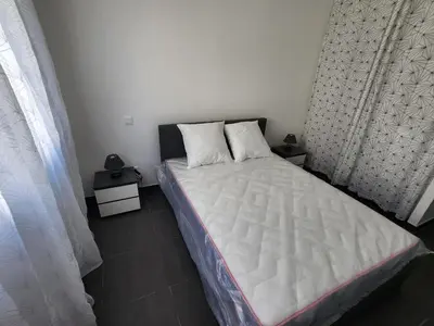 a bedroom with a bed with a white mattress at La Villa les Terrasses du Canal in Capestang
