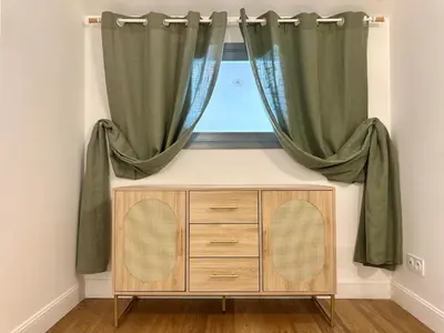 a room with a window with curtains and a dresser at Duplex T2 de haut-standing in Narbonne