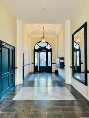 an empty hallway with a black door and mirrors at Duplex T2 de haut-standing in Narbonne