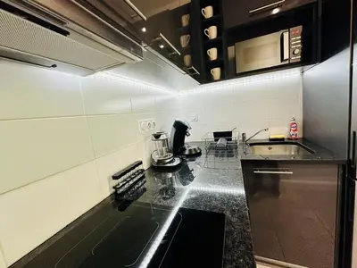 a kitchen with a sink and a counter top at Duplex T2 de haut-standing in Narbonne
