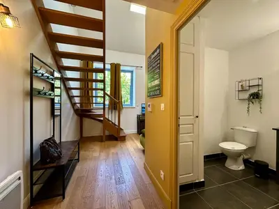 a hallway with a staircase and a toilet in a house at Duplex T2 de haut-standing in Narbonne