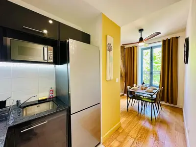 a kitchen with a sink and a table with a dining room at Duplex T2 de haut-standing in Narbonne