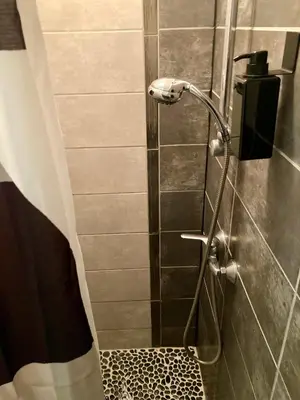 a shower with a shower head in a bathroom at Le Repaire Légendaire in Carcassonne