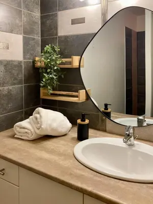 a bathroom counter with a sink and a mirror at Le Repaire Légendaire in Carcassonne
