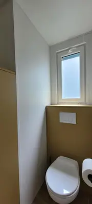 a bathroom with a white toilet and a window at Studiotel premium 2 personnes in Pamiers