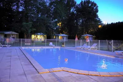 a large swimming pool with chairs at Studiotel premium 2 personnes in Pamiers