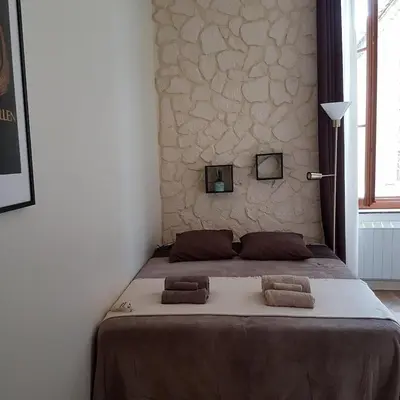 a bedroom with a bed with two pillows on it at Gîte de la tour avec piscine entre Carcassonne et narbonne in Capendu