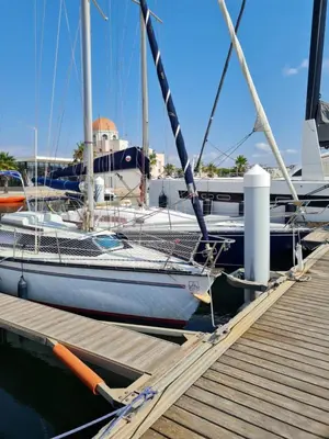 a sailboat is docked at a dock at Quatre Vent in Gruissan