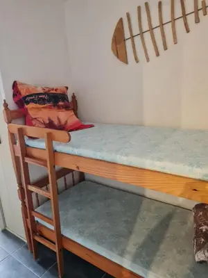 a bed with a wooden desk with a chair next to it at Quatre Vent in Gruissan