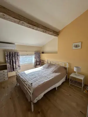 a bedroom with a bed in a room with a window at Gîte de Montplo-Cruzy in Cruzy