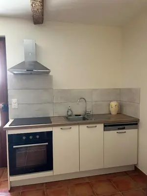 a kitchen with a sink and a stove at Gîte de Montplo-Cruzy in Cruzy