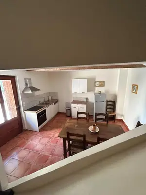 a kitchen and dining room with a table and chairs at Gîte de Montplo-Cruzy in Cruzy