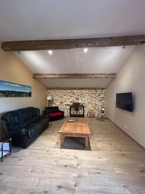 a living room with a couch and a table at Gîte de Montplo-Cruzy in Cruzy