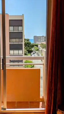 a window with a view of a building at LE FIEF, T2 au pied de la plage, Climatisation in Port-la-Nouvelle
