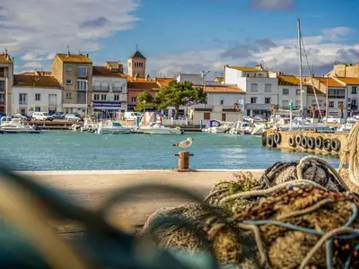 a bird sitting on a fire hydrant in a marina at LE FIEF, T2 au pied de la plage, Climatisation in Port-la-Nouvelle
