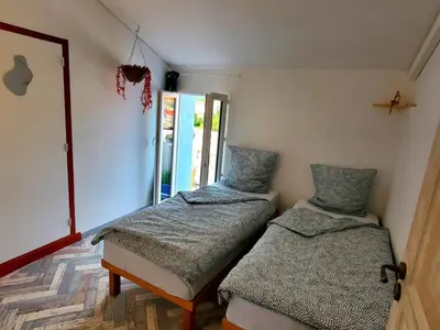 a room with two twin beds in a room at Renovated and air-conditioned 2-bedroom apartment with terrace in Saint-Paul-de-Fenouillet