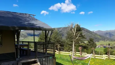 an old church on top of a hill with a valley at Lodge Holidays - Les Sapins in Camurac