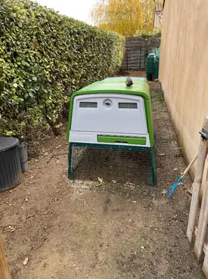 a green and white toaster on a stand next to a fence at House in a rural village surrounded by vineyards in Leuc