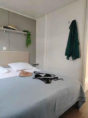 a bedroom with a bed with a hat on it at Cap du Roc in Port-la-Nouvelle