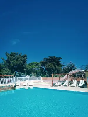 a large swimming pool with lounge chairs at Cap du Roc in Port-la-Nouvelle