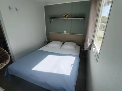 a small bedroom with a bed and a window at Cap du Roc in Port-la-Nouvelle