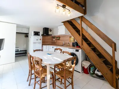 a kitchen with a table and chairs in a kitchen at Villa T3 à Gruissan avec climatisation et jardin - FR-1-409A-36 in Gruissan