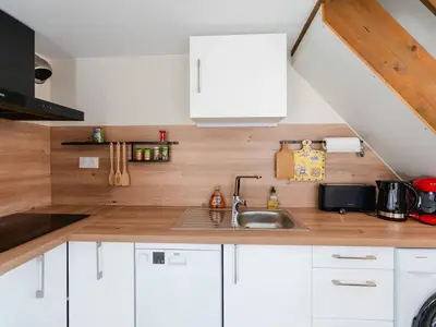 a kitchen with white cabinets and a sink at Villa T3 à Gruissan avec climatisation et jardin - FR-1-409A-36 in Gruissan